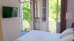 阿列日河畔的塔拉斯孔Hôtel Confort 09 ou HC-09的一间卧室设有一张床和一个滑动玻璃门