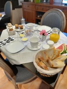 Senouillac拉威格尼洛尼尚布里斯住宿加早餐旅馆的一张桌子,上面放着一盘面包和橙汁