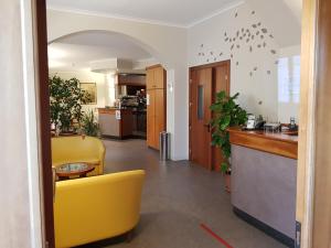 阿斯蒂Hotel Cavour的大堂设有黄色椅子和厨房