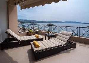 托隆国王米诺斯酒店 的阳台设有两张沙发,享有水景