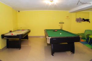 扎科帕内Willa Michałówka的黄色墙壁的客房内设有两张台球桌