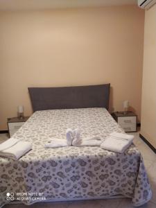 阿尔塔穆拉Panorama Lucano的一间卧室,床上有两双白鞋