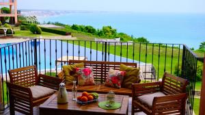 托波拉Луксозни Апартаменти Калиакрия - Luxurious Apartments in Kaliakria Resort的一个带桌椅的海景庭院