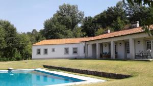 Várzea Ovelha e AliviadaQuinta do Ladário的一座房子前面设有游泳池