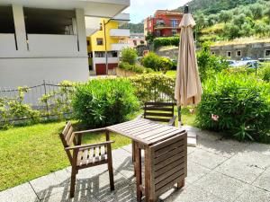 莱万托MARIO Apartment with Garden的庭院里配有桌椅和遮阳伞