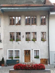 格吕耶尔格吕耶尔尚塔尔太阳公寓 的前面有鲜花的砖房