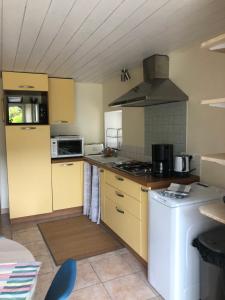 Poullan-sur-MerTy Kergavan - calme et tranquilité au bord de la baie的厨房配有黄色橱柜和炉灶烤箱