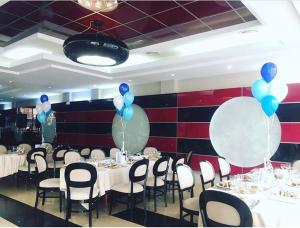 克卢日-纳波卡Hotel Pami的一间设有白色桌子和蓝色气球的用餐室