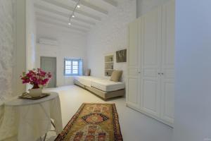 伊兹拉Vita Real Estate的白色的大房间,配有床和桌子