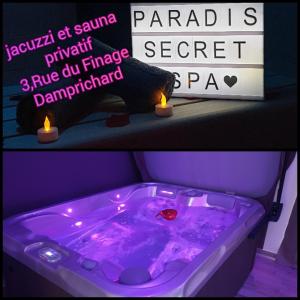 DamprichardParadis Secret Spa的紫色浴缸,带蜡烛和标志