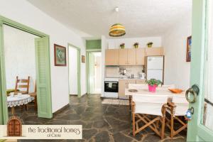 伊罗达Elounda Collection Apartments的厨房以及带桌椅的用餐室。