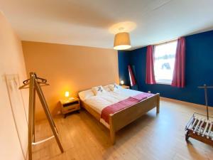 MadulainMadulain Lodge @ Werkhof的一间卧室配有一张蓝色墙壁的床和一扇窗户