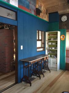 驹根市一棟貸し宿bochi-bochi的一间设有桌子和蓝色墙壁的用餐室