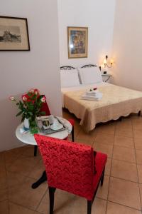 佛罗伦萨Dei Mori - Guest House的配有一张床和一张桌子及椅子的房间