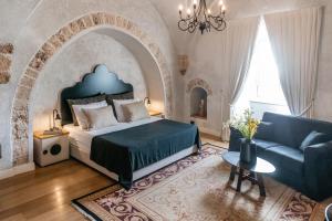 特拉维夫诺娃 - 豪华套房及精品公寓式酒店的一间卧室配有一张大床和一张沙发