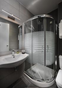 约阿尼纳拜占提奥酒店的一间带玻璃淋浴和水槽的浴室