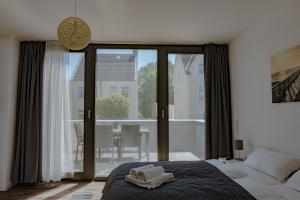 拉博埃Meeresrauschen的一间卧室设有一张床和一个大型玻璃门