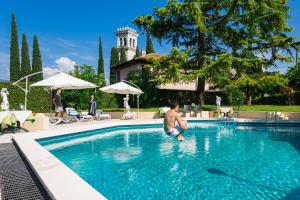 托斯科拉诺-马德尔诺亚德里亚度假酒店的一个人在游泳池里