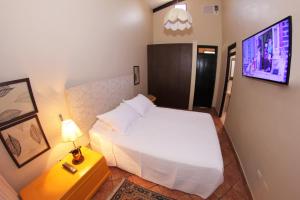 拉梅尔塞Fundo San Jose Parque Ecológico & Lodge Hotel Asociado Casa Andina的卧室配有一张床,墙上配有电视。