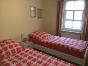 埃姆登Klaassen- Ferienhaus Up Warf的卧室内的两张床和一张 ⁇ 子毯子