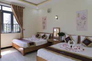 昆岛Thanh Trang Hotel的酒店客房设有两张床和窗户。