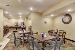 RouzervilleCobblestone Hotel & Suites - Waynesboro的一间带桌椅和柜台的餐厅