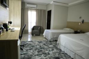 东普里马韦拉Tezla Hotel的酒店客房配有两张床和一张书桌