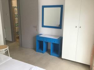 KamariotissaVilla Maria的蓝色的橱柜,配有镜子和蓝色的桌子