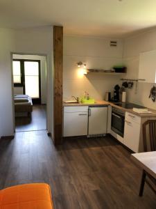 拉德施塔特上蒂芬巴公寓的一间配备有白色家电和桌子的小厨房