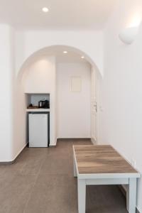 米克诺斯城Magic View Suites Mykonos的一间空房间,配有桌子和厨房