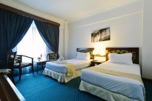 马六甲马来西亚马六甲赛丽酒店的酒店客房设有两张床和窗户。