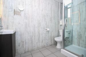 格拉斯哥City Apartments的一间带卫生间和玻璃淋浴间的浴室
