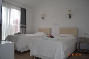 费特希耶乌戈尔酒店的白色墙壁客房的两张床