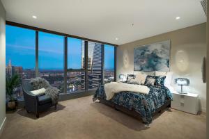 墨尔本Platinum Luxury Stays at Freshwater Place的一间卧室设有一张床和一个大窗户