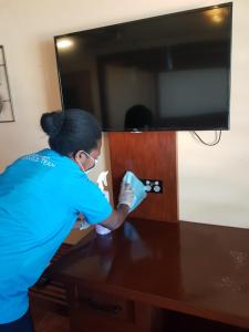 维拉港法图马鲁小屋酒店的女人正在用毛巾清洗桌子