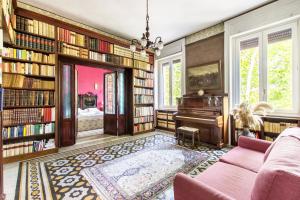 罗马特拉斯提弗列装饰公寓的客厅配有书架和钢琴