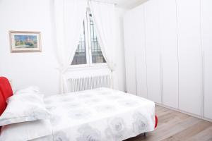 维拉诺瓦La MaGiA di Villa的白色的卧室设有床和窗户