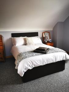 巴利米纳The Tree-house B&B的一间卧室配有一张带黑白色棉被的床