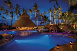 蓬塔卡纳Dreams Royal Beach Punta Cana - All Inclusive的棕榈树的度假村的游泳池