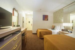 皇后区法拉盛中央酒店的酒店客房设有两张床和一台平面电视。