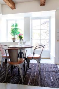 维斯比Visby City Apartments S:t Hansgatan的一间带桌椅和窗户的用餐室