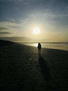 巴利巴宁McMunns of Ballybunion的日落时在海滩上散步的人