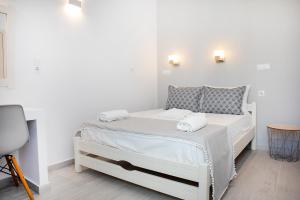 帕罗奇亚格罗索斯酒店的客房内的白色床和2条毛巾