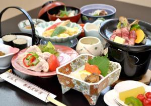 花卷市Dai Onsen Matsudaya Ryokan - Vacation STAY 67479的桌子上放着一碗食物的桌子