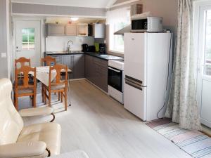SørbøHoliday Home Fjordperlen - FJS145 by Interhome的厨房配有白色冰箱和桌子