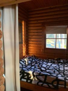 纳坦利Velkuanmaa Lomamökki的小木屋内一间卧室,配有一张床