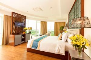芹苴宁侨河滨酒店的一间卧室设有一张大床,部分设有窗户。
