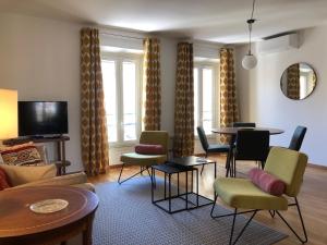 戛纳LE BAIN DE SOLEIL luxury 2 bedrooms Cannes centre的客厅配有桌椅和沙发