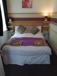 布莱克浦加内特酒店的一间卧室配有一张床,上面有两条毛巾