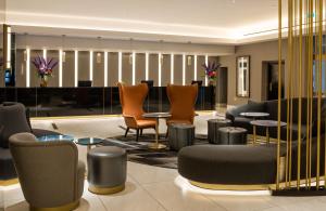 伦敦斯特兰德宫酒店的大堂设有桌椅和钢琴